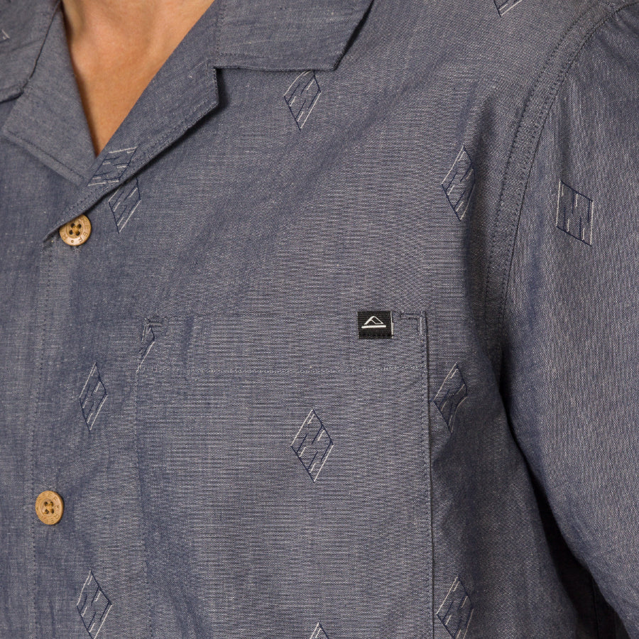 Close-up of the chest pocket on the Harold Camp Shirt featuring a subtle patterned design and beach-inspired comfort.