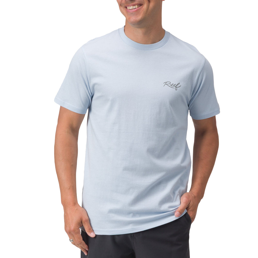 Man wearing a light blue Marlinrita Tee facing forward, showcasing a comfortable, beach-inspired casual style.