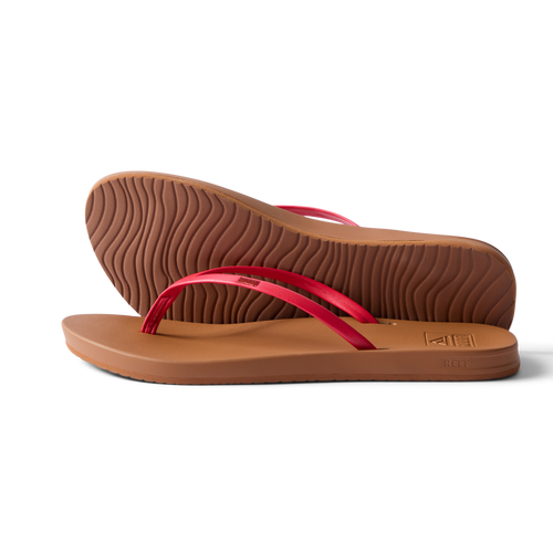 Pair of Cushion Slim women's sandals facing right, side and sole view, red straps, beach-inspired water-friendly design.