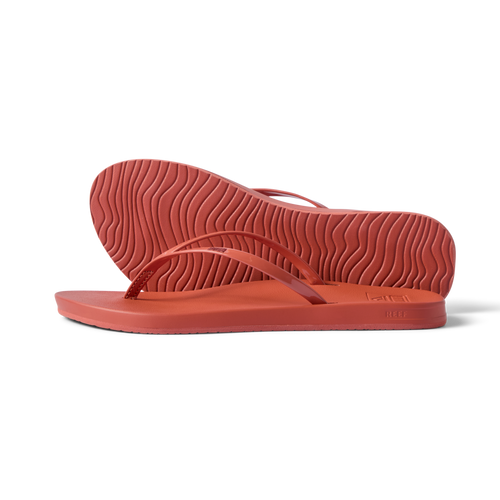 Side view of women's Cushion Slim flip flops in coral, showing sole and slim straps with arch support, water-friendly and comfortable.