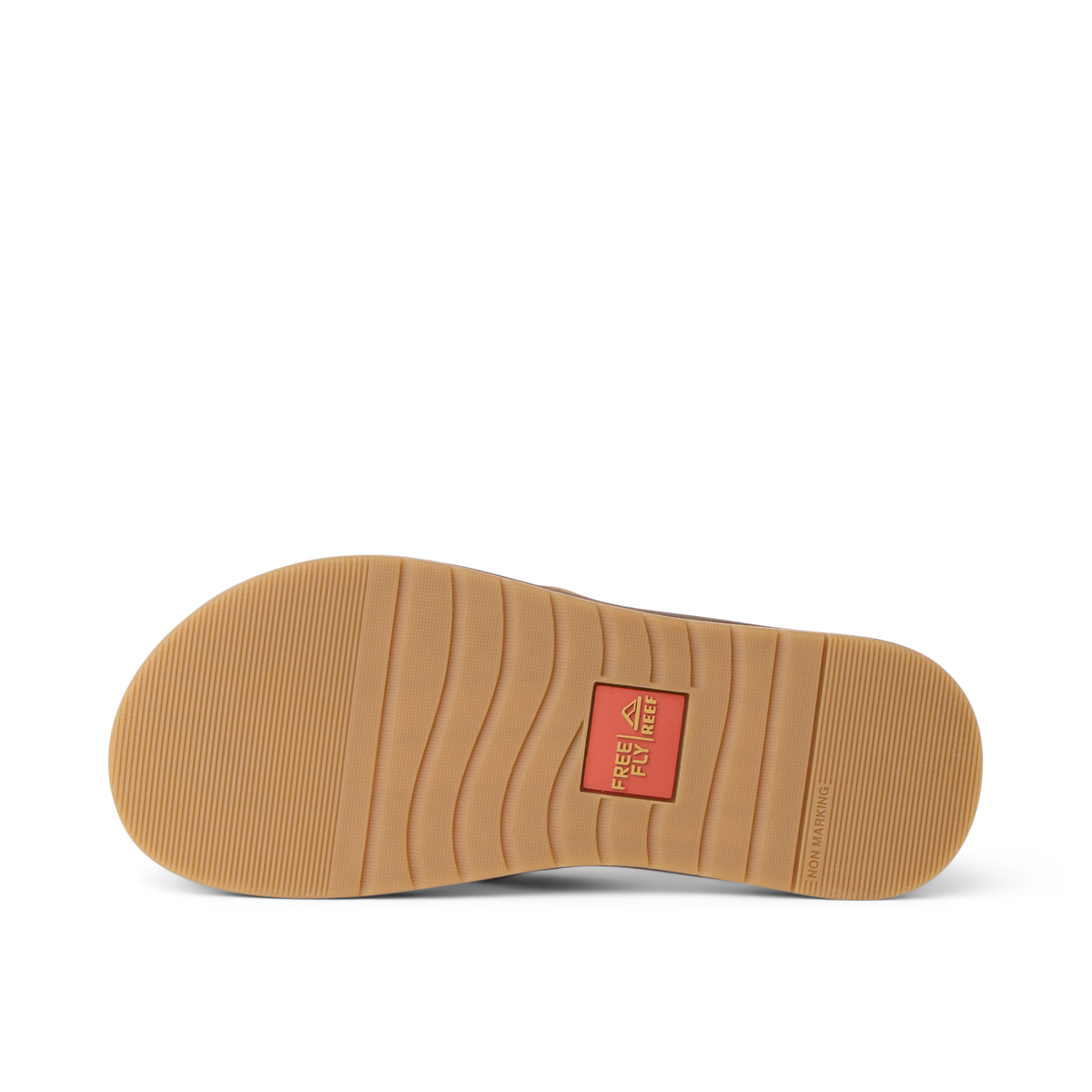 Free Fly X Ojai sandal outsole facing up, showing durable rubber tread with flex grooves and branded logo patch center
