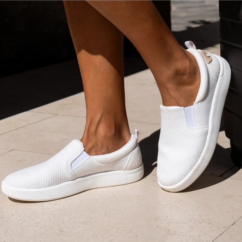 Side view of white Neptune Elyse slip-on shoes for women showing comfort cushioning and lightweight design