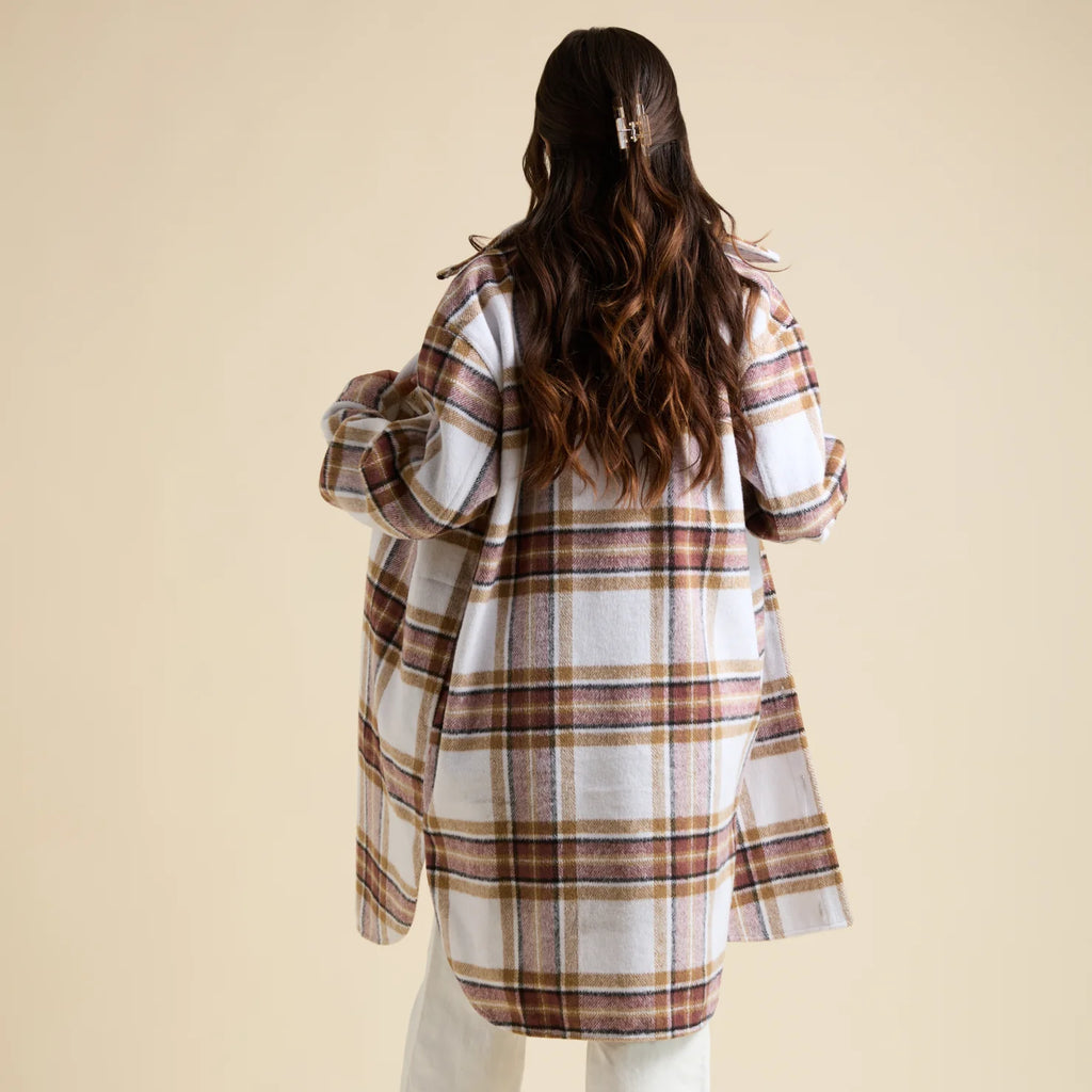 Woman wearing a plaid Victoria Shacket with brown and white tones, shown from the back highlighting its relaxed fit and soft fabric.