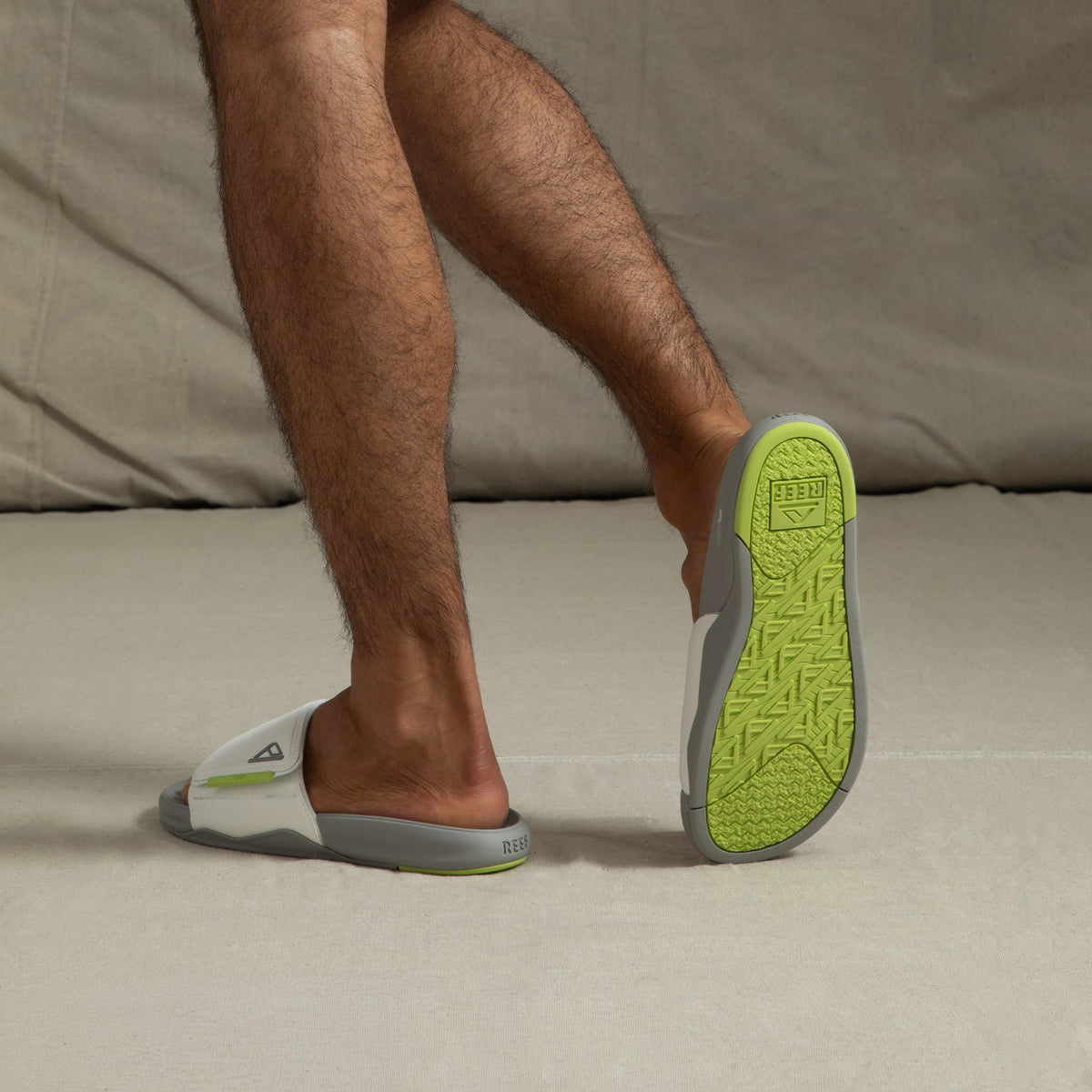 Phantom Slab men's slides facing backward showing lime green outsole with arch support and extra cushioning.