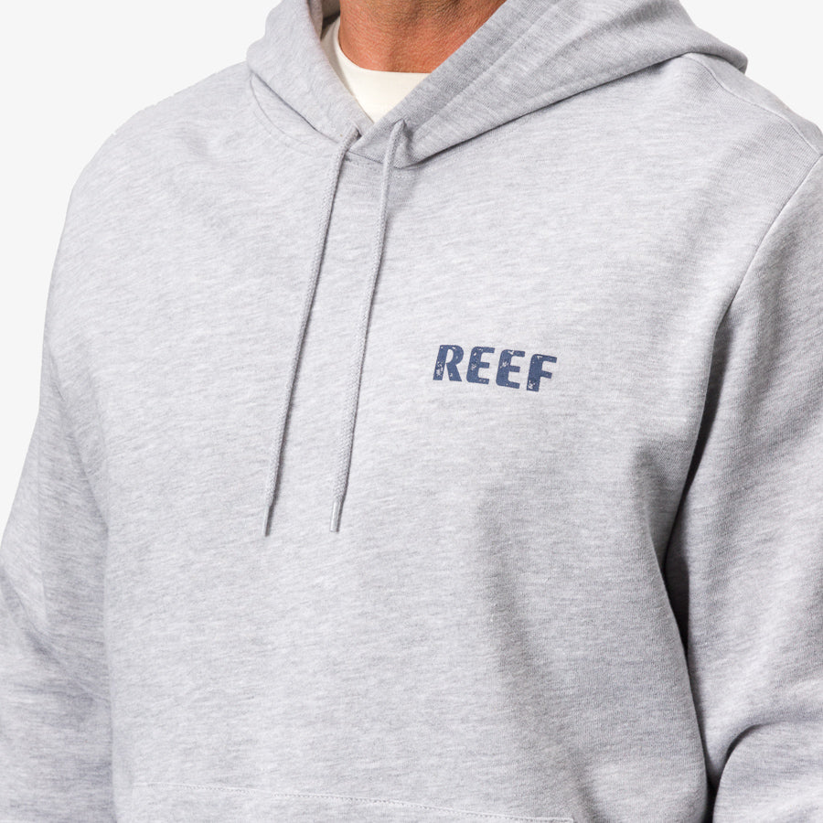 Close-up of the front upper chest of the Wellie Too Hoodie in heather grey showcasing soft fabric and REEF branding.